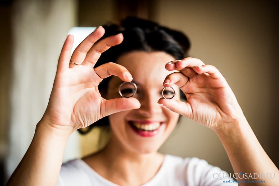 bride smiling with wedding rings