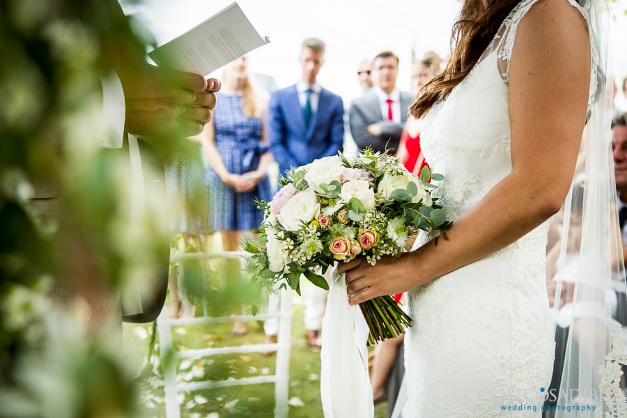 groom vows detail bouquet