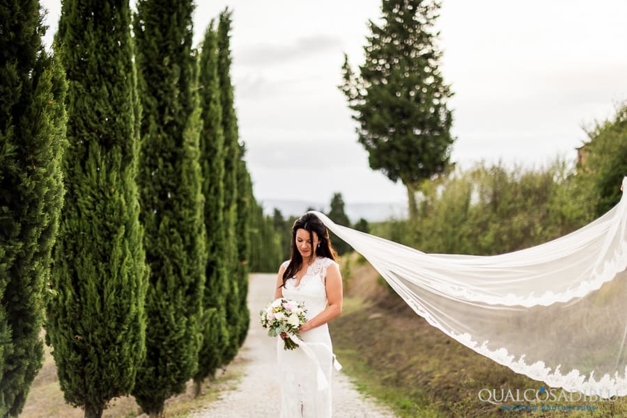 bride portrait with veil with cypresses in the background