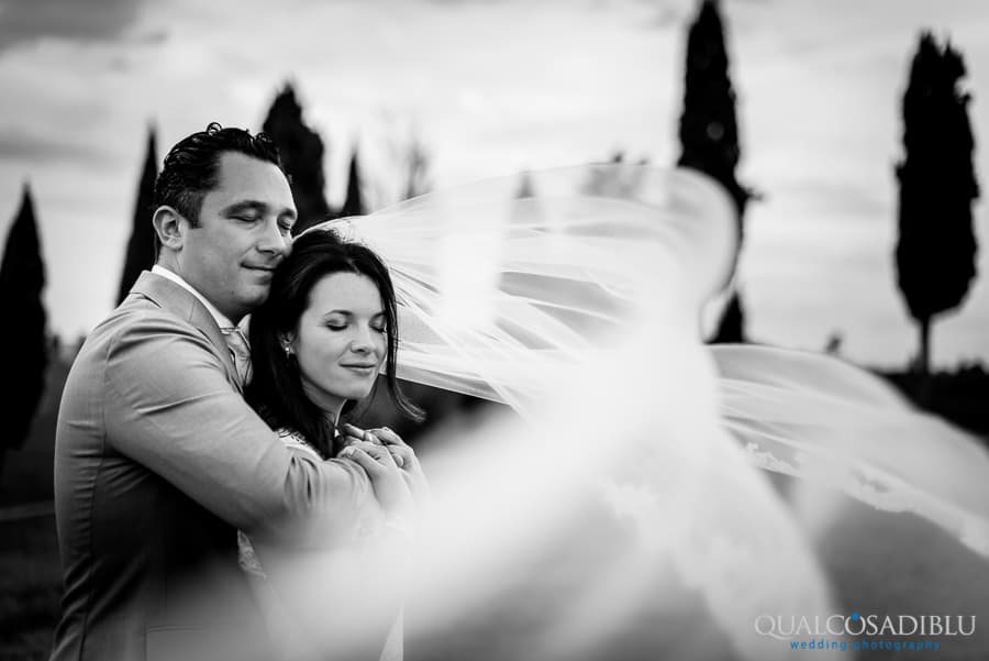 bride and groom embraced veil black and white