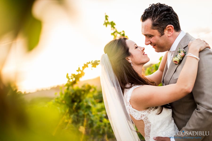 newlywed kissing in the vineyard