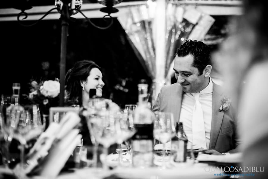 groom smiling candid moment dinner black and white