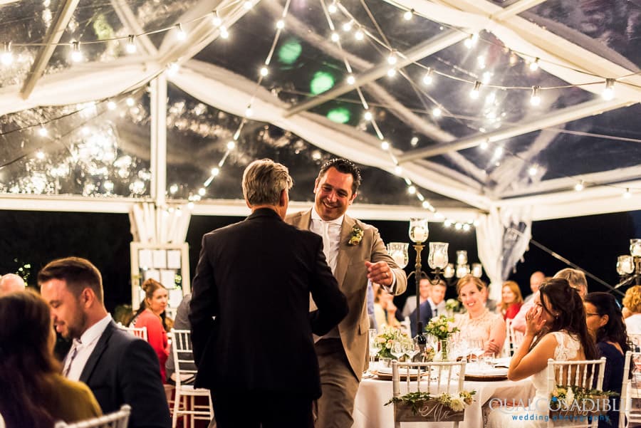 father of the bride and groom embraced