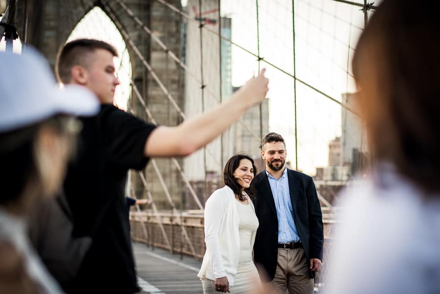 engaged couple walking on the brooklyn bridge