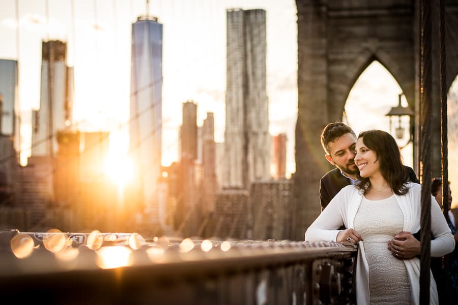 Embraced lovely couple at sunset on the brooklyn bridge