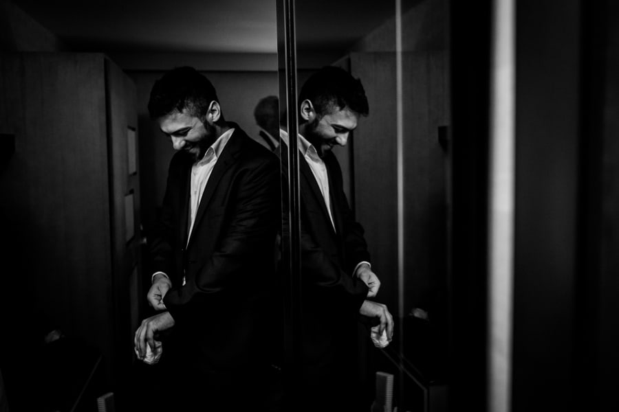 Wedding getting ready black and white groom smiling