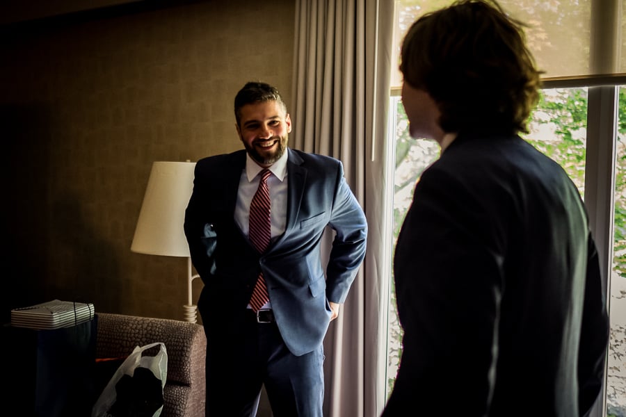 Wedding groom getting ready smiling hotel zero degrees ct