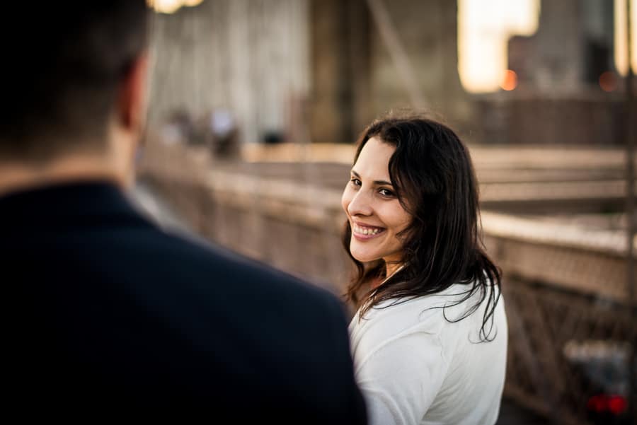 lady smiling brooklyn bridge new york