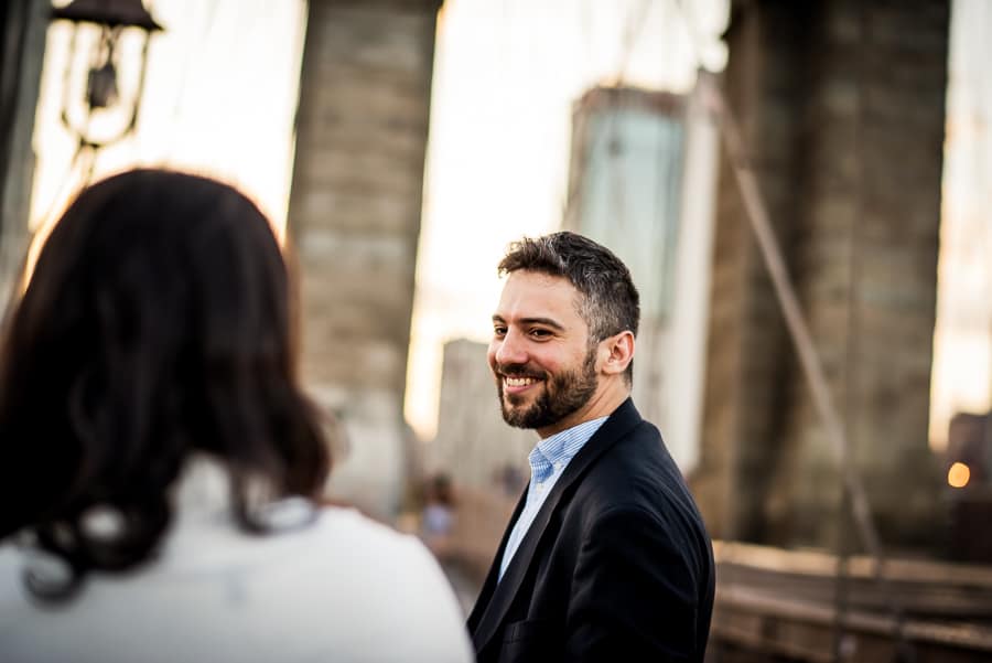 man smiling brooklyn bridge new york