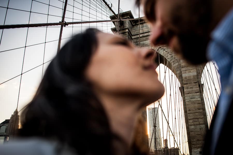 blurry couple kissing brooklyn bridge background