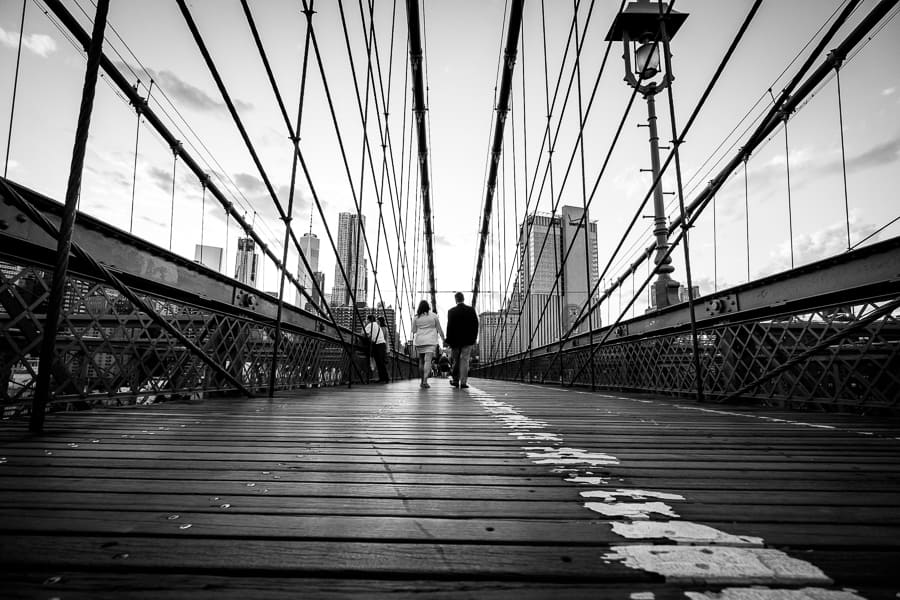 hand by hand engaged couple brooklyn bridge walking