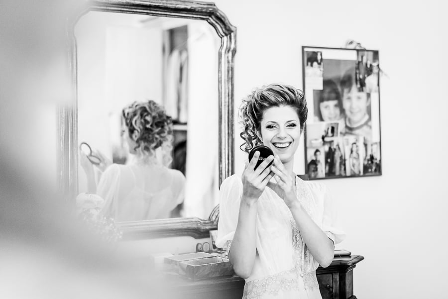 bride smiling looking at mirror