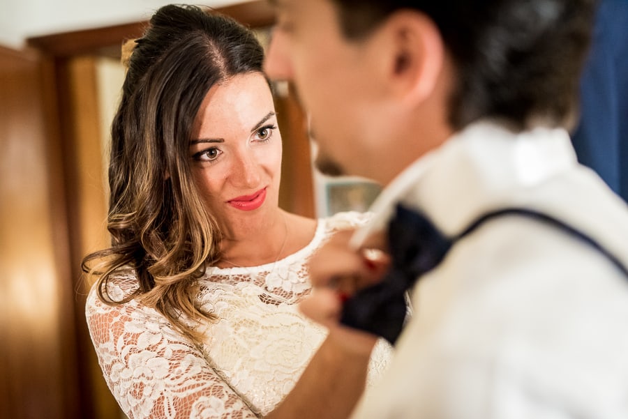 sister of groom adjusting bow tie