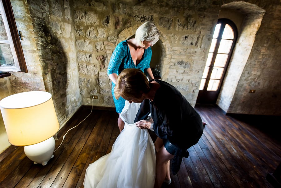 mother of the bride preparing the wedding dress