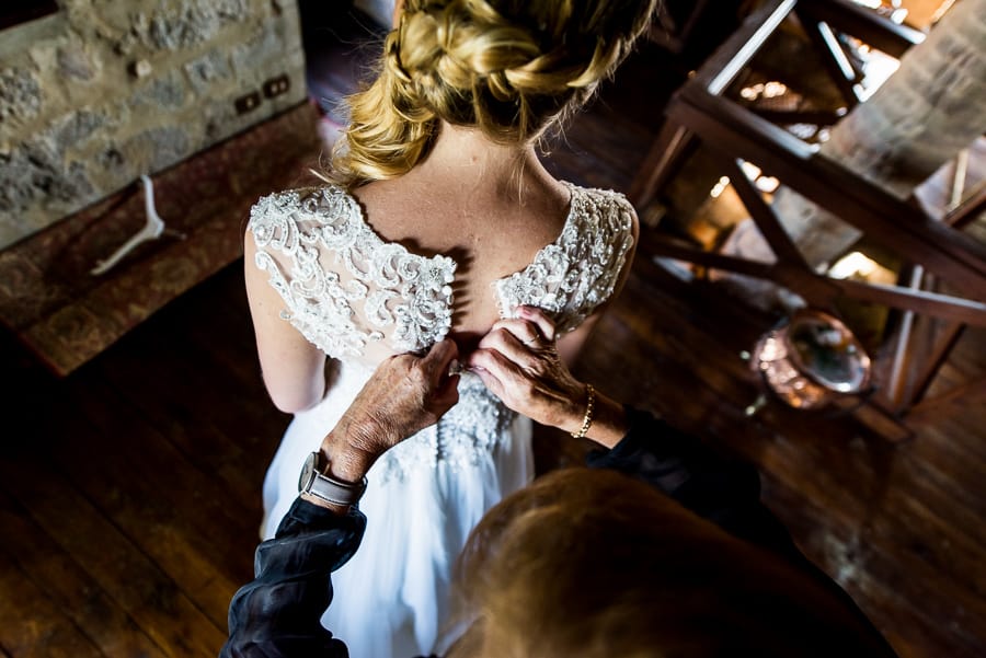 mother of the bride lacing the wedding dress