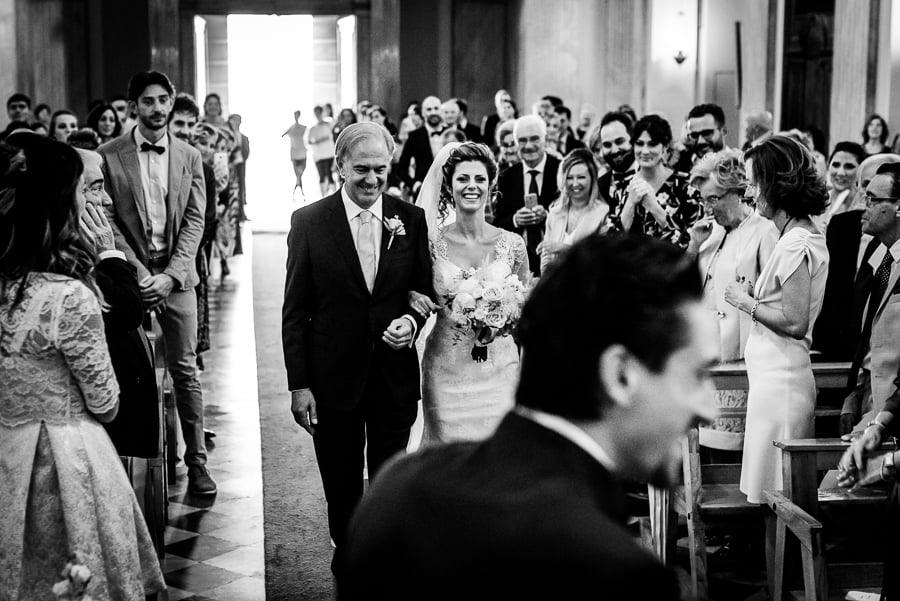 father and bride walking thru the aisle church