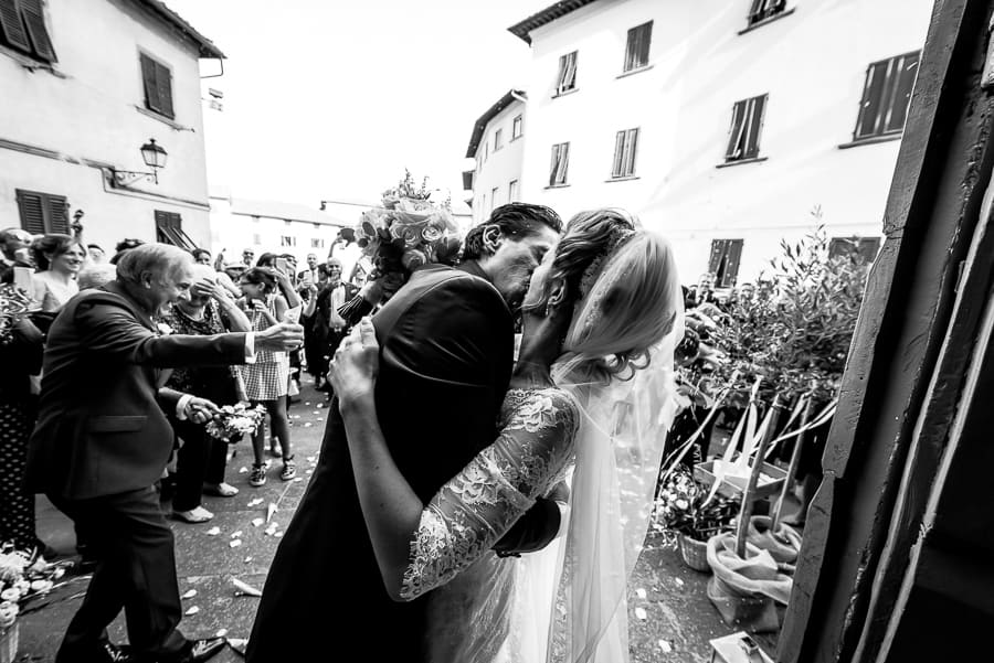 bride groom kissing black and white