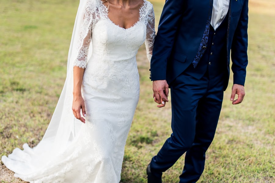 bride and groom wlaking together holdings their hand