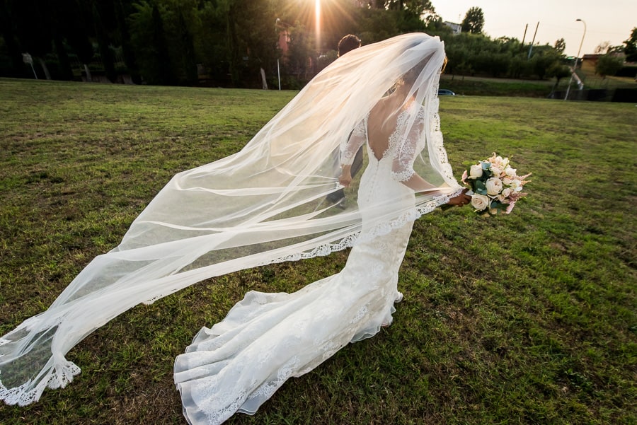 bride walking with long veil