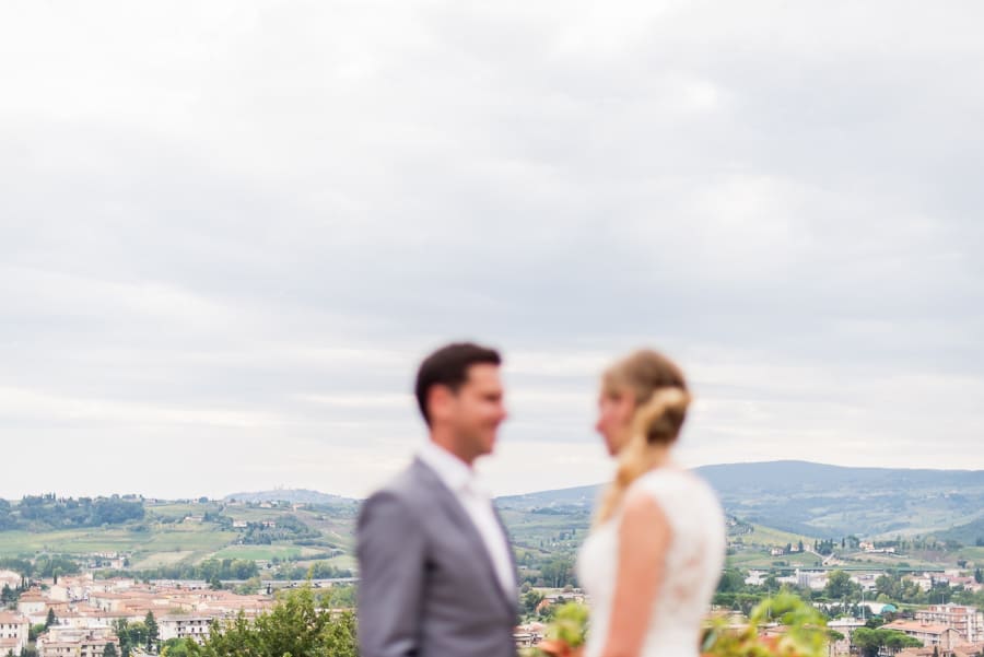 bride groom blurred with tuscany landscape backdrop