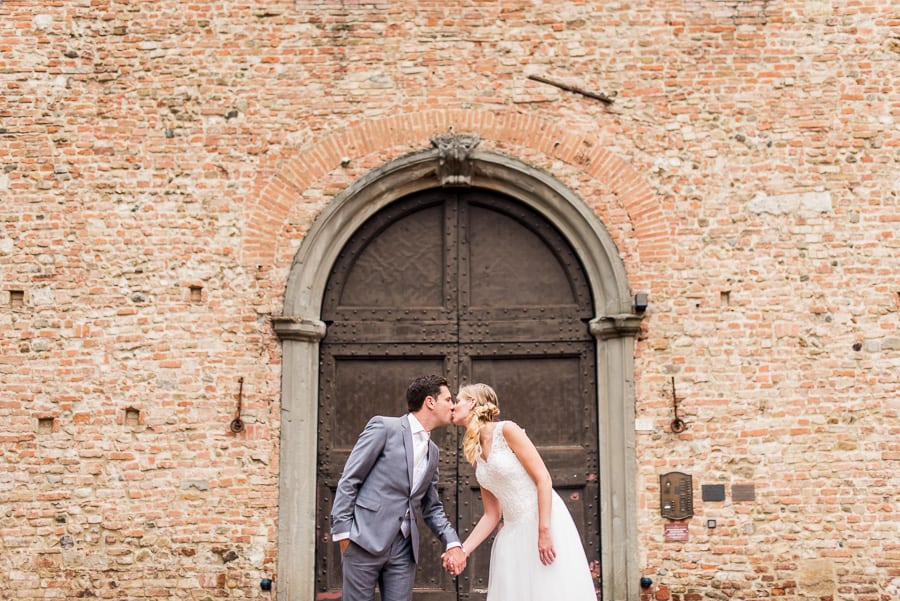 wedding couple kissing ancient big door certaldo