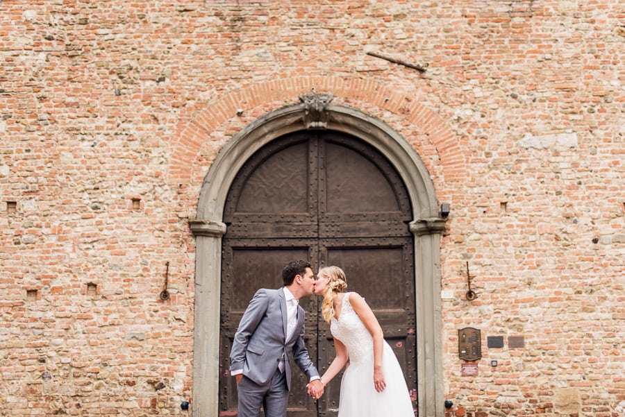 wedding couple kissing ancient big door certaldo