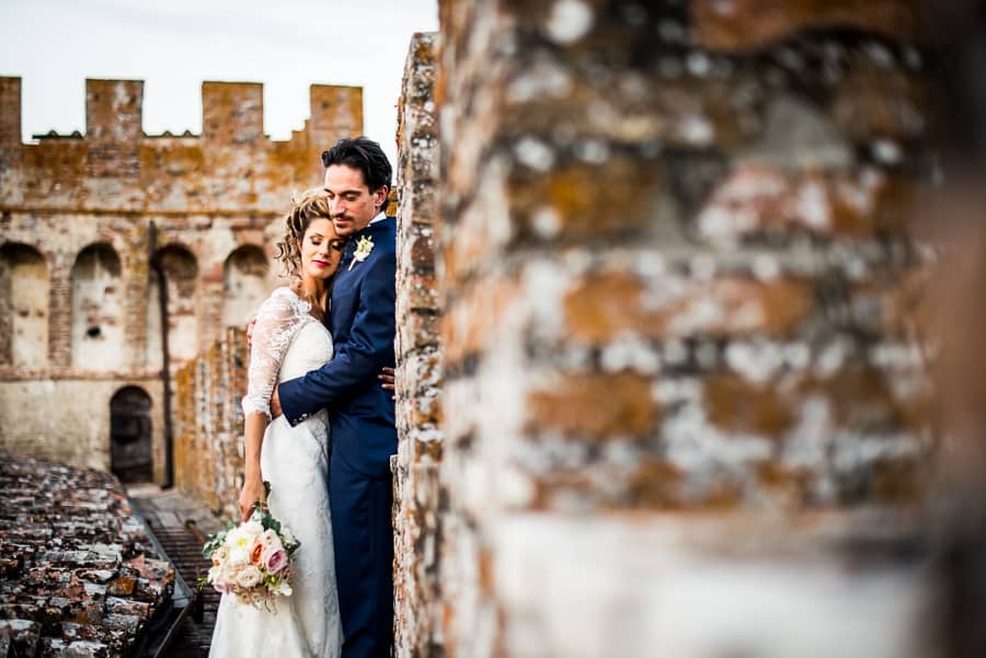 bride groom intimate embraced walls castle oliveto