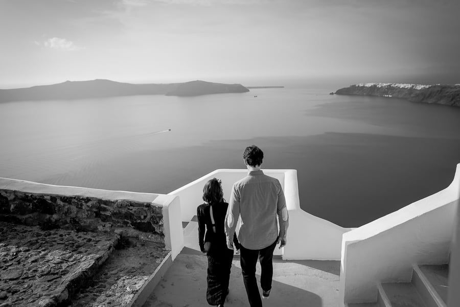 couple walking in santorini with caldera view