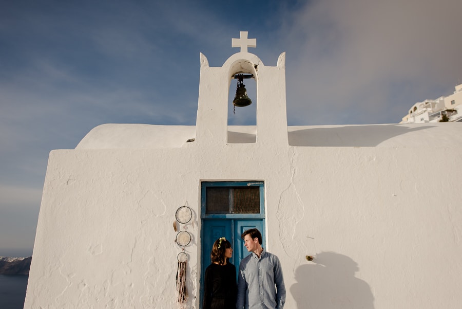 couple engaged in a church at imerovigli