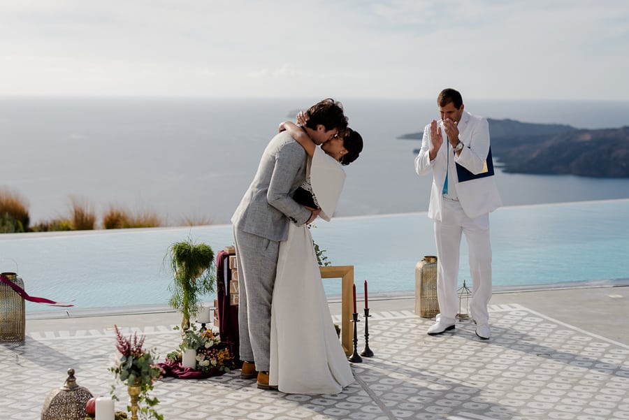 bride and groom embracing each other wedding ceremony santorini