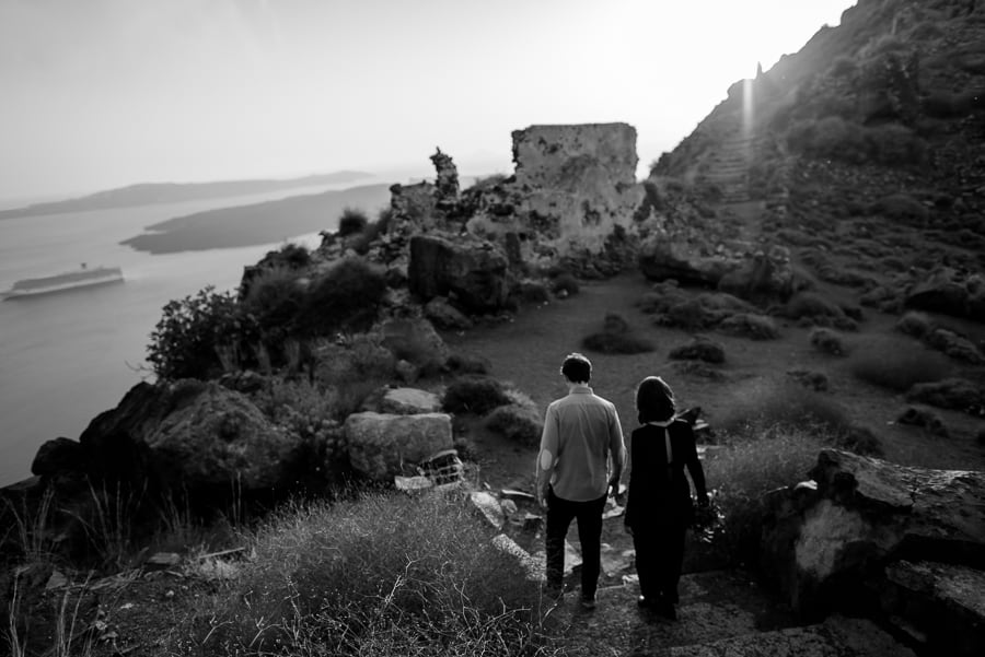 couple engaged walking to skaros rock santorini