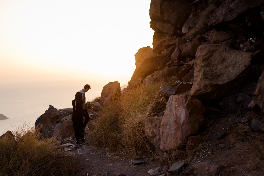 engaged couple walking in skaros rock sunset magic light