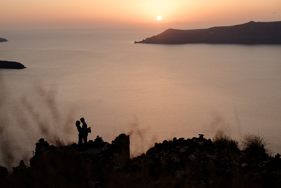 couple embraced sunset skaros rock imerovigli santorini