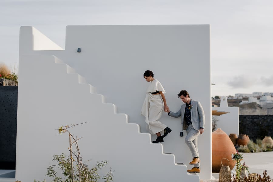 bride and groom going up to a typical building santorini wedding