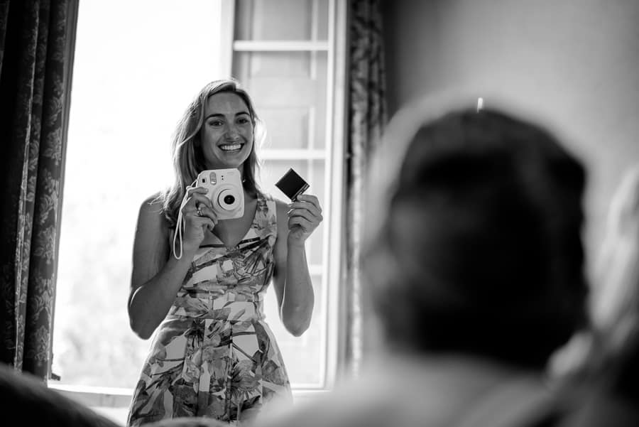 bride shooting with polaroid camera