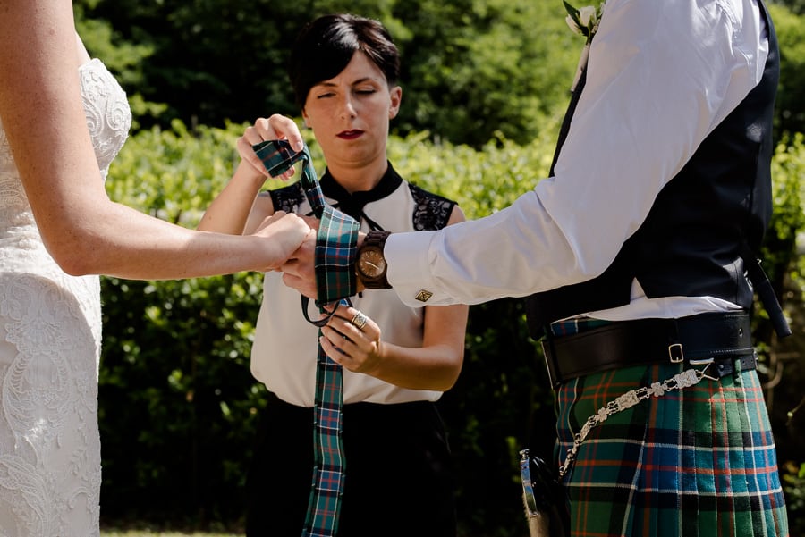 tie the tie to the hands of the bride and groom