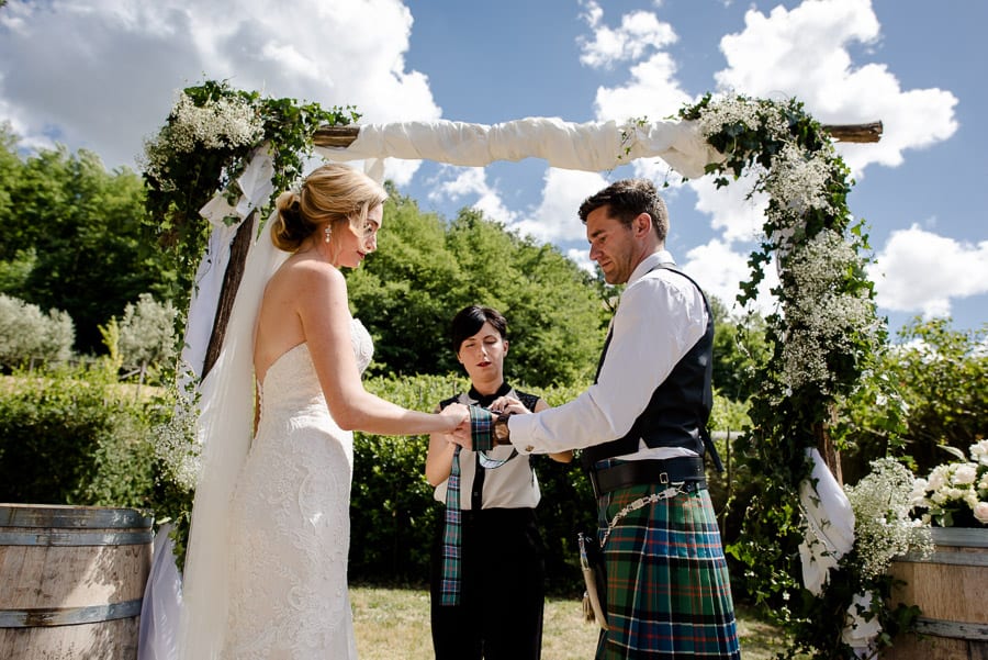 Bride and groom with the tie tied on their hands