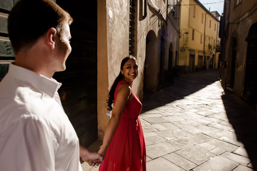 woman with red dress walking in Lucca