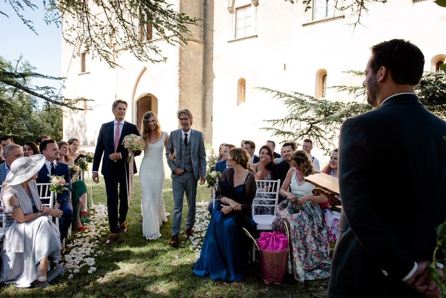 the bride walking down to the aisle with father