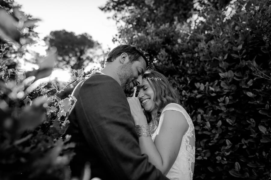 bride and groom hug black and white