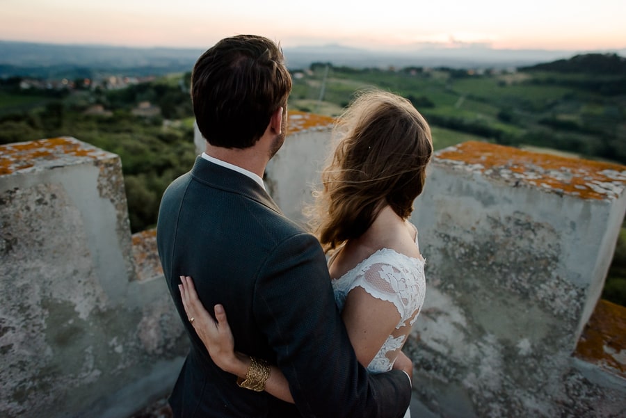 bride and groom watching the sunset