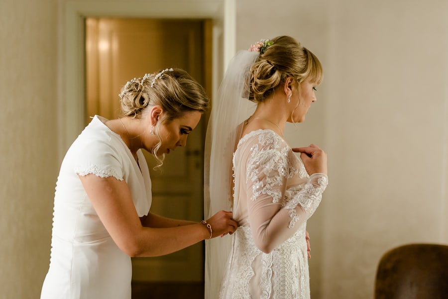 Bride getting ready fixing the dress