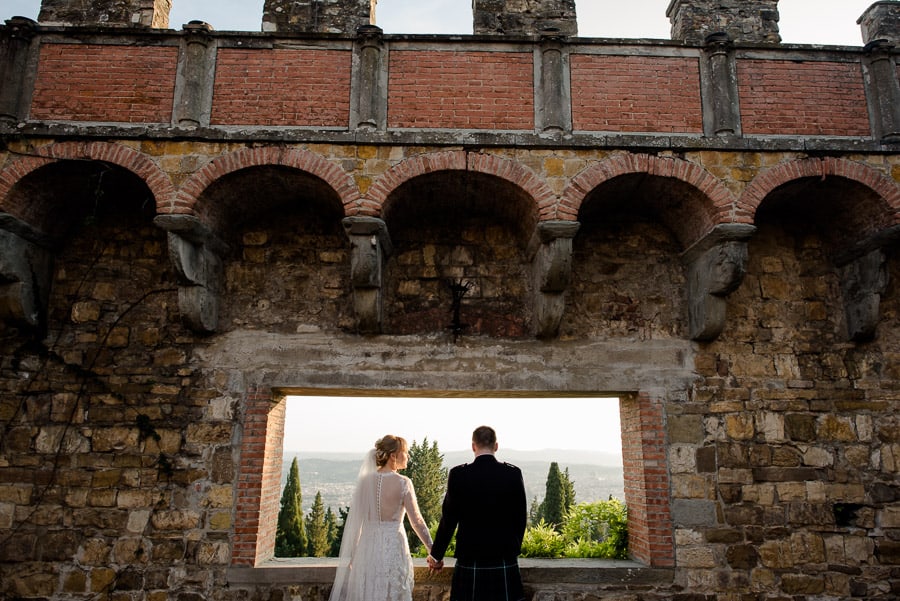 bride and groom window in the sky vincigliata castle florence