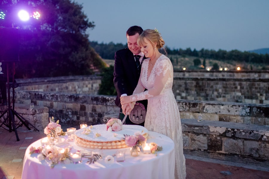 Bride and Groom are cutting the cake