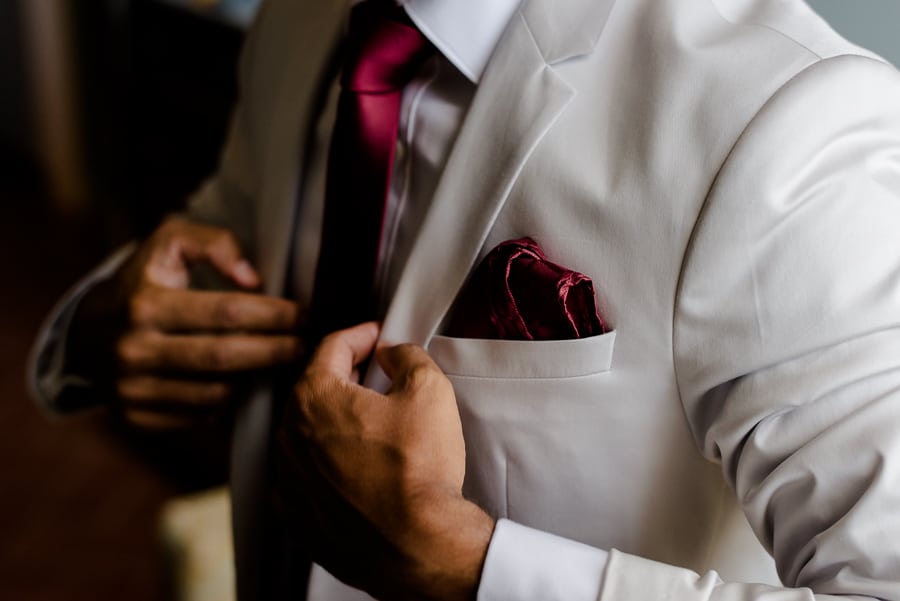 Getting ready of the groom wearing the jacket