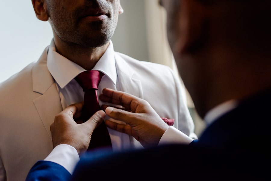 Bestman of the groom adjusting the necktie