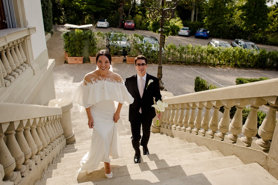 Bride and groom walking in the stairs