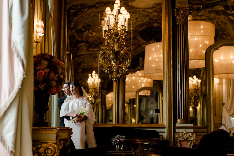 Bride and groom embraced in the mirror room