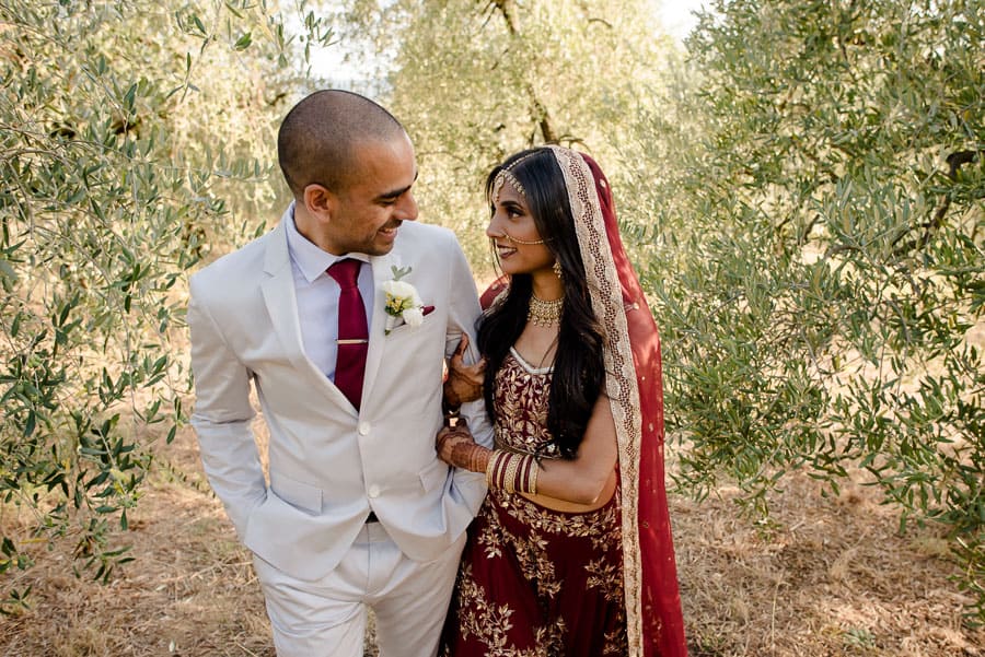 Indian bride and groom walking in the hills in Lucca