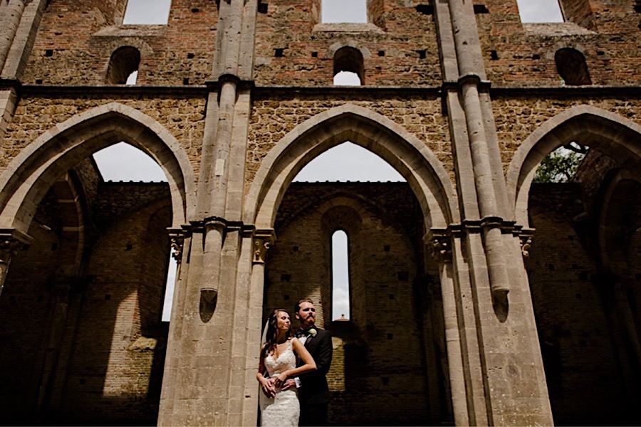 Bride and groom embraced at san galgano abbey